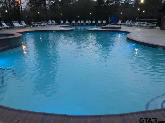 a view of swimming pool and outdoor seating