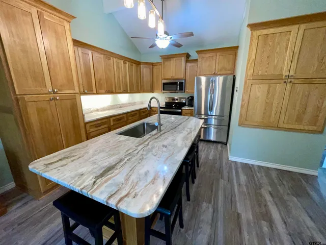 a kitchen with a table chairs refrigerator and microwave
