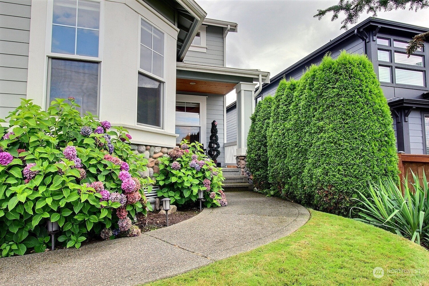 1029 North 34th Street Renton, WA 98056 - Photo 4 of 39 a view of a house with potted plants
