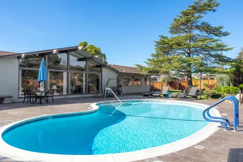 a backyard of a house with outdoor seating