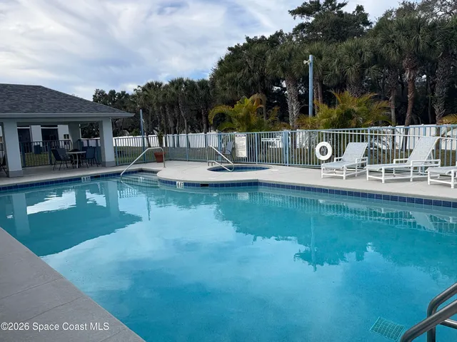 a view of house with swimming pool and sitting area