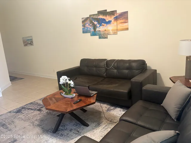a living room with furniture a couch and wooden floor