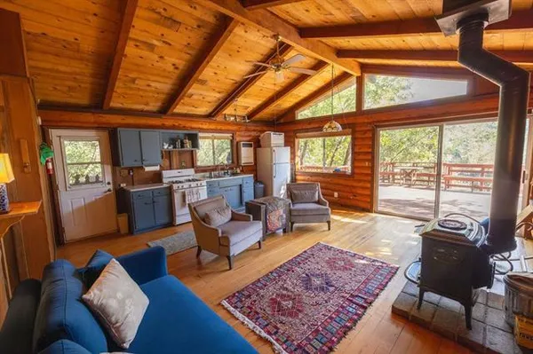 a living room with furniture and a open kitchen view