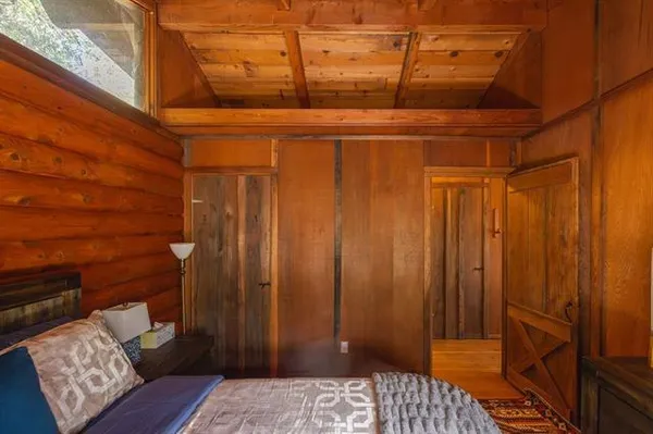 a bedroom with a bed and next to a window