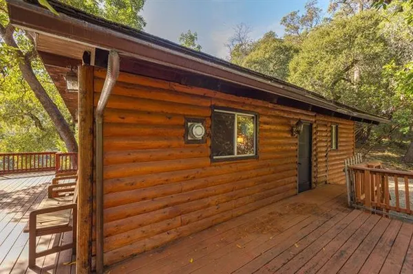 a view of a house with a yard and wooden fence
