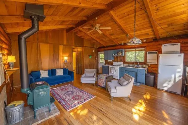 a living room with furniture a rug and a table