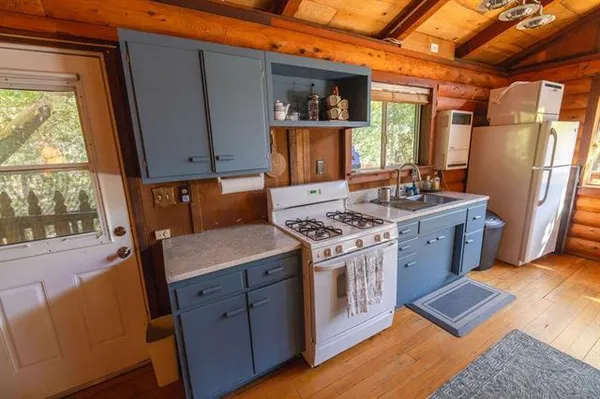 a kitchen with sink refrigerator and window