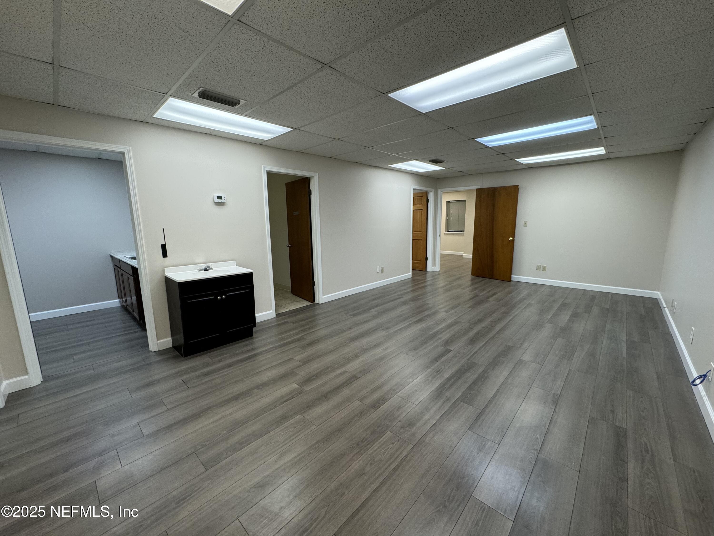 3938 Sunbeam Road Jacksonville, FL 32257 - Photo 15 of 28 a view of empty room with wooden floor