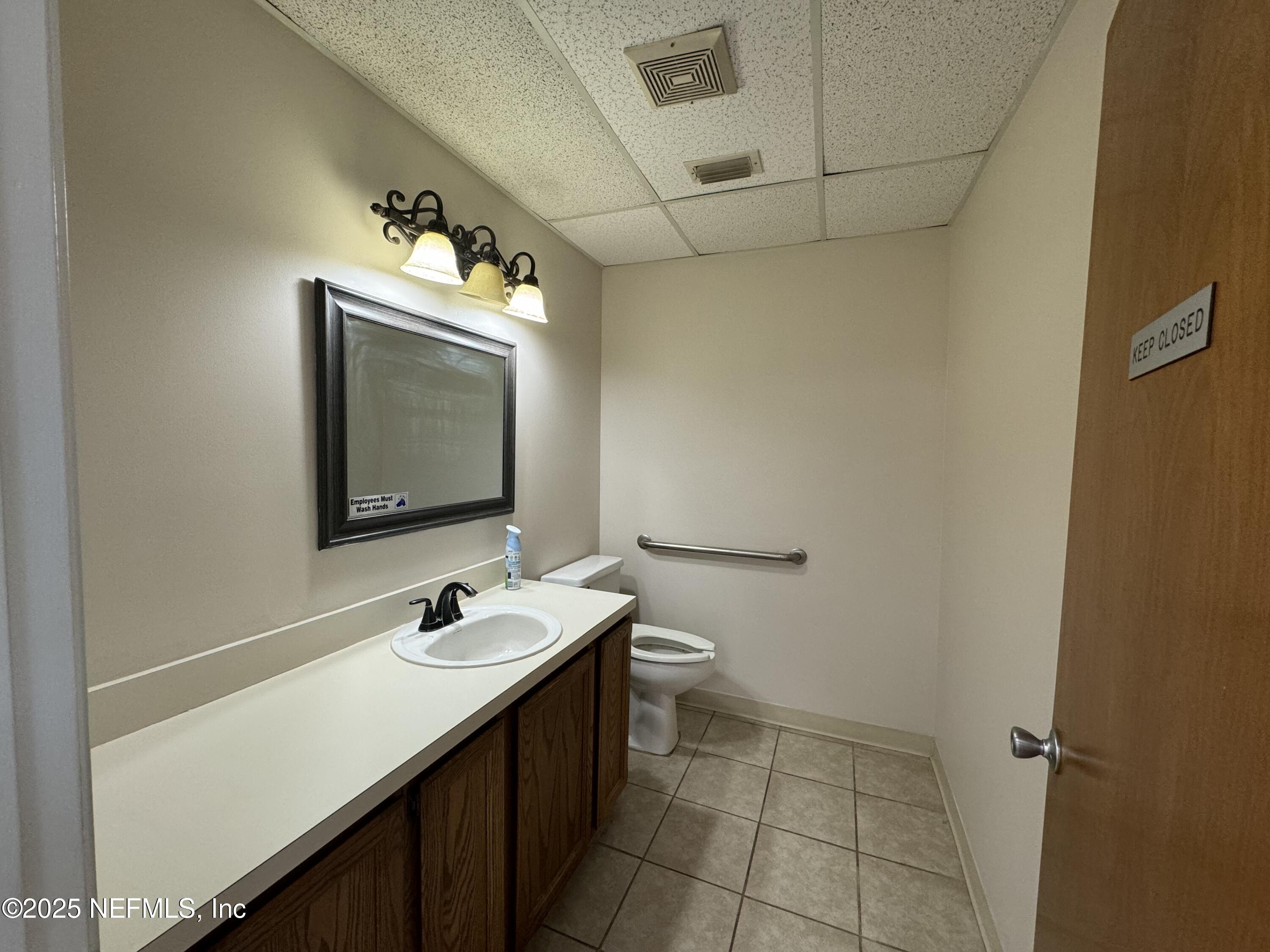3938 Sunbeam Road Jacksonville, FL 32257 - Photo 16 of 28 a bathroom with a sink and a mirror