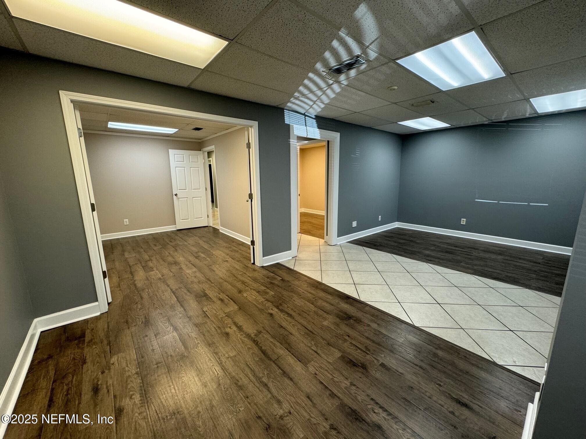 3938 Sunbeam Road Jacksonville, FL 32257 - Photo 17 of 28 a view of empty room with wooden floor