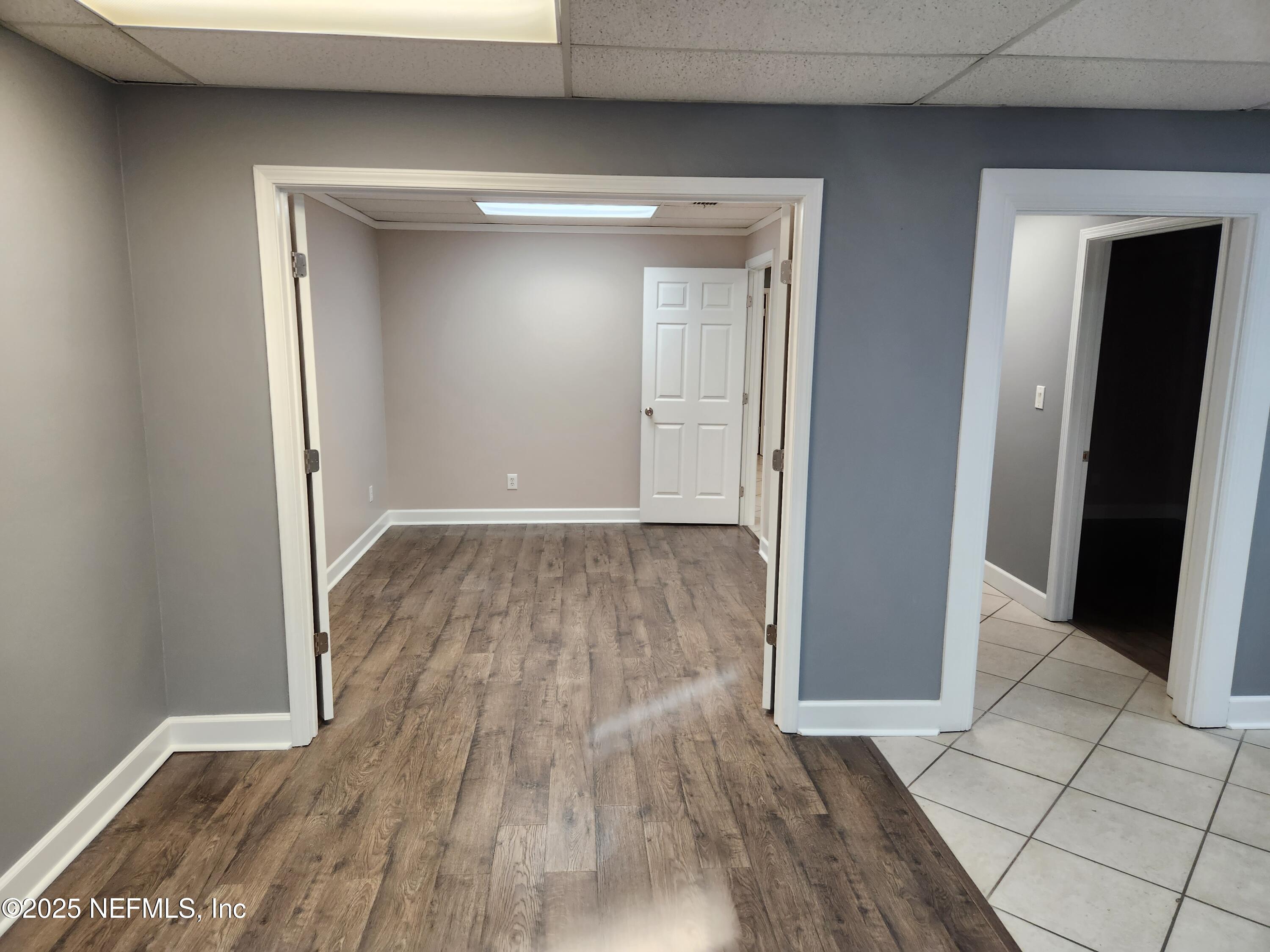 3938 Sunbeam Road Jacksonville, FL 32257 - Photo 18 of 28 wooden floor in an empty room