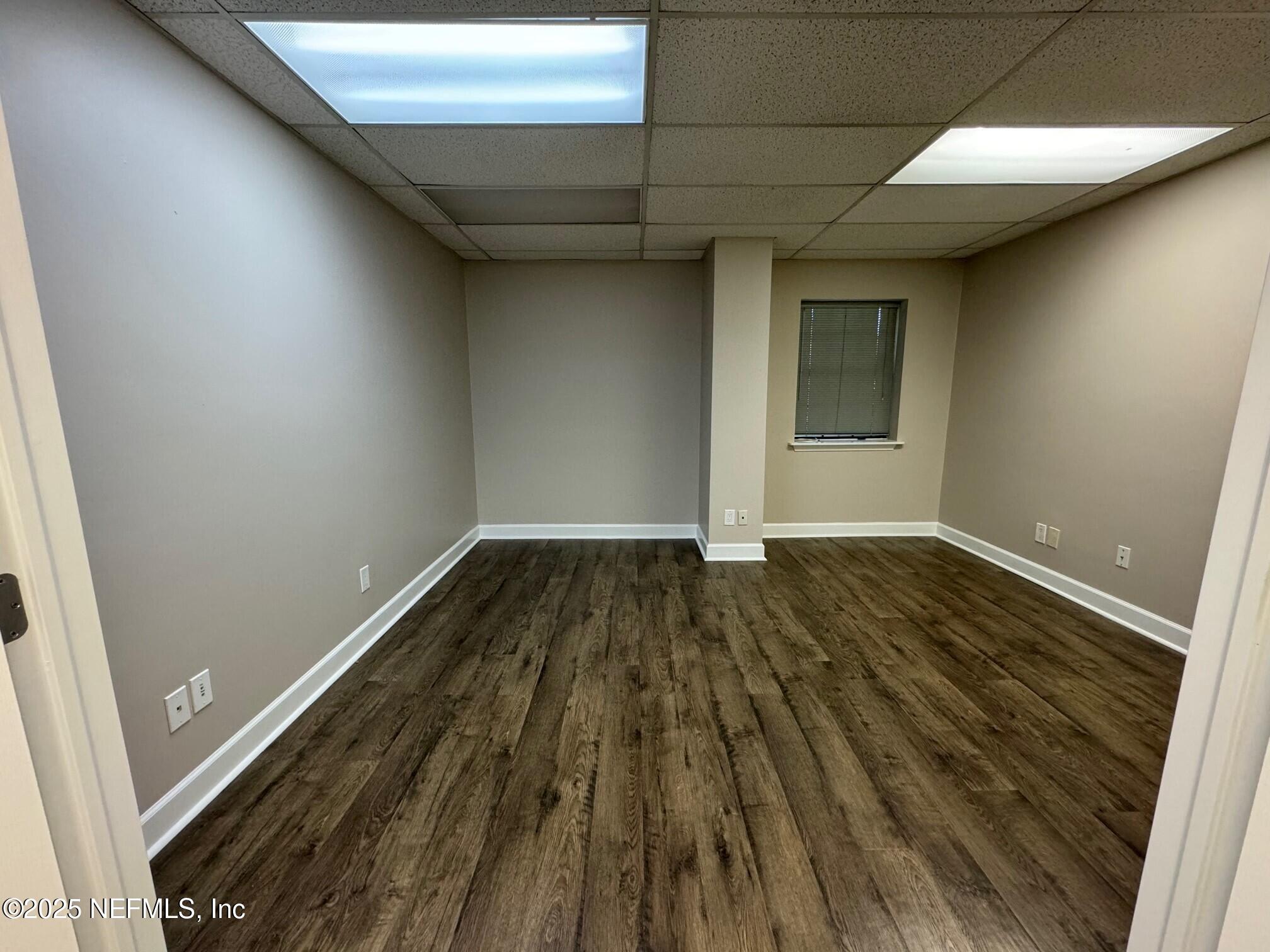 3938 Sunbeam Road Jacksonville, FL 32257 - Photo 20 of 28 a view of a room with wooden floor and bench