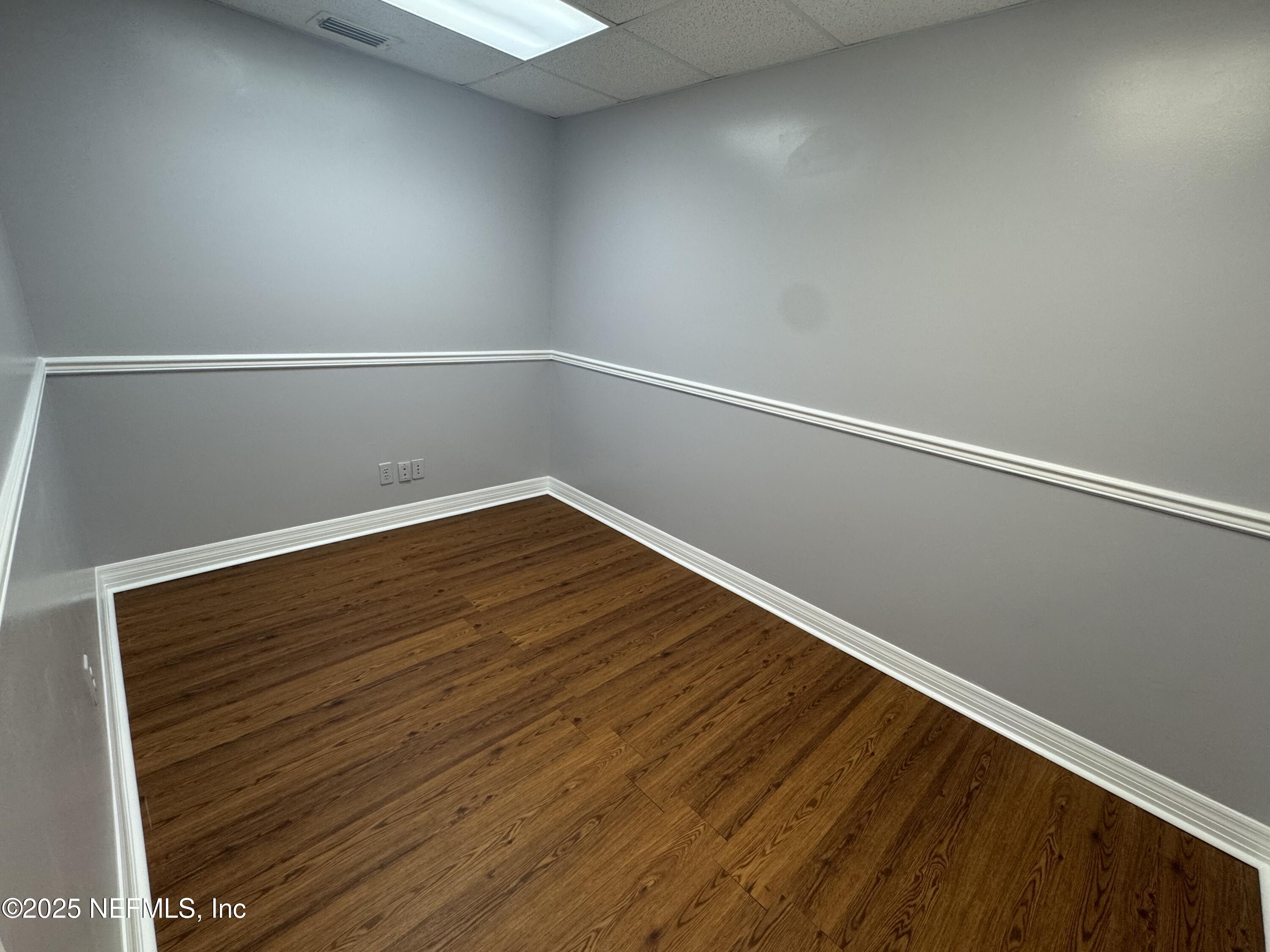 3938 Sunbeam Road Jacksonville, FL 32257 - Photo 24 of 28 a view of an empty room with wooden floor