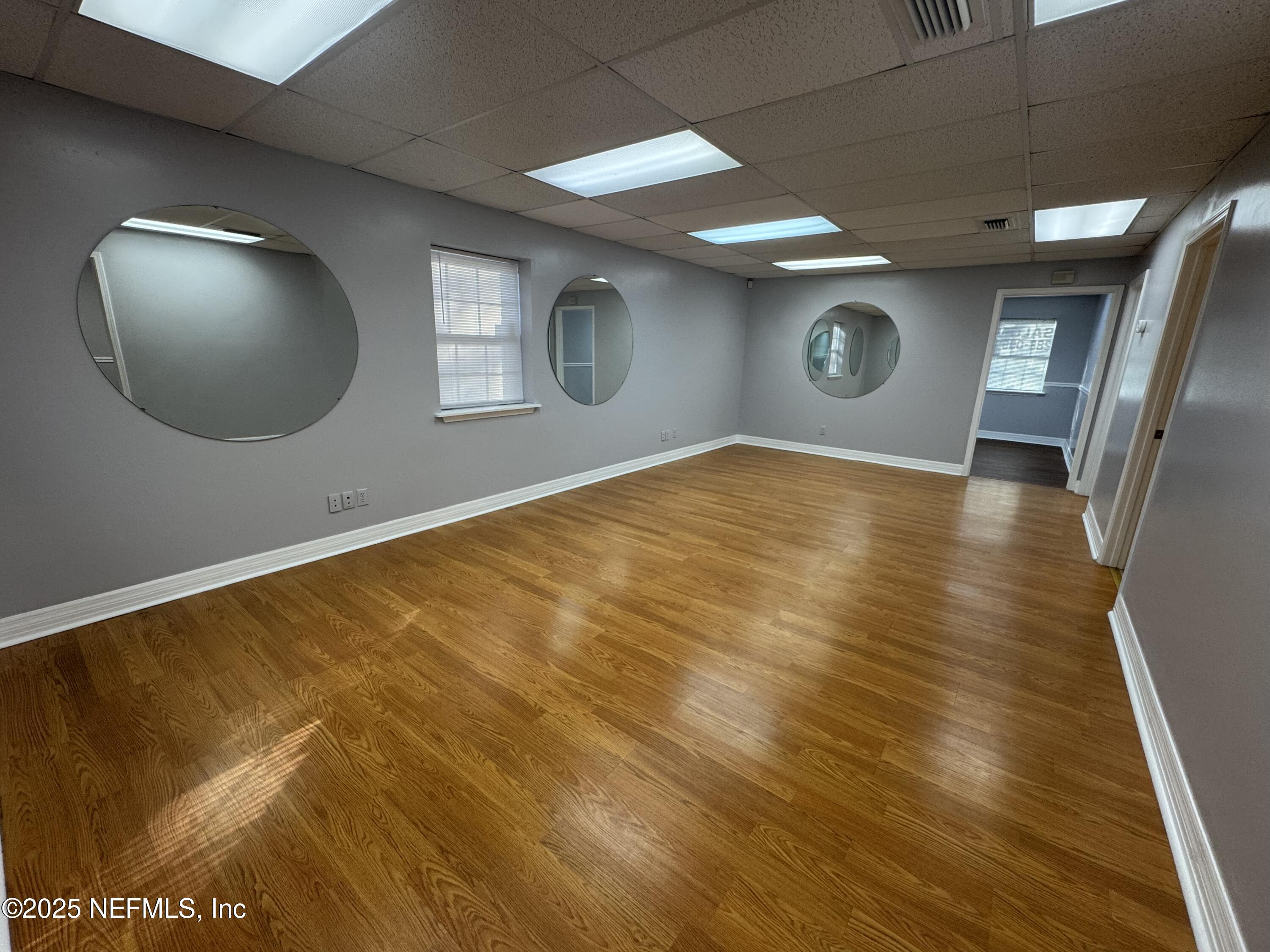 3938 Sunbeam Road Jacksonville, FL 32257 - Photo 25 of 28 a view of an empty room and wooden floor