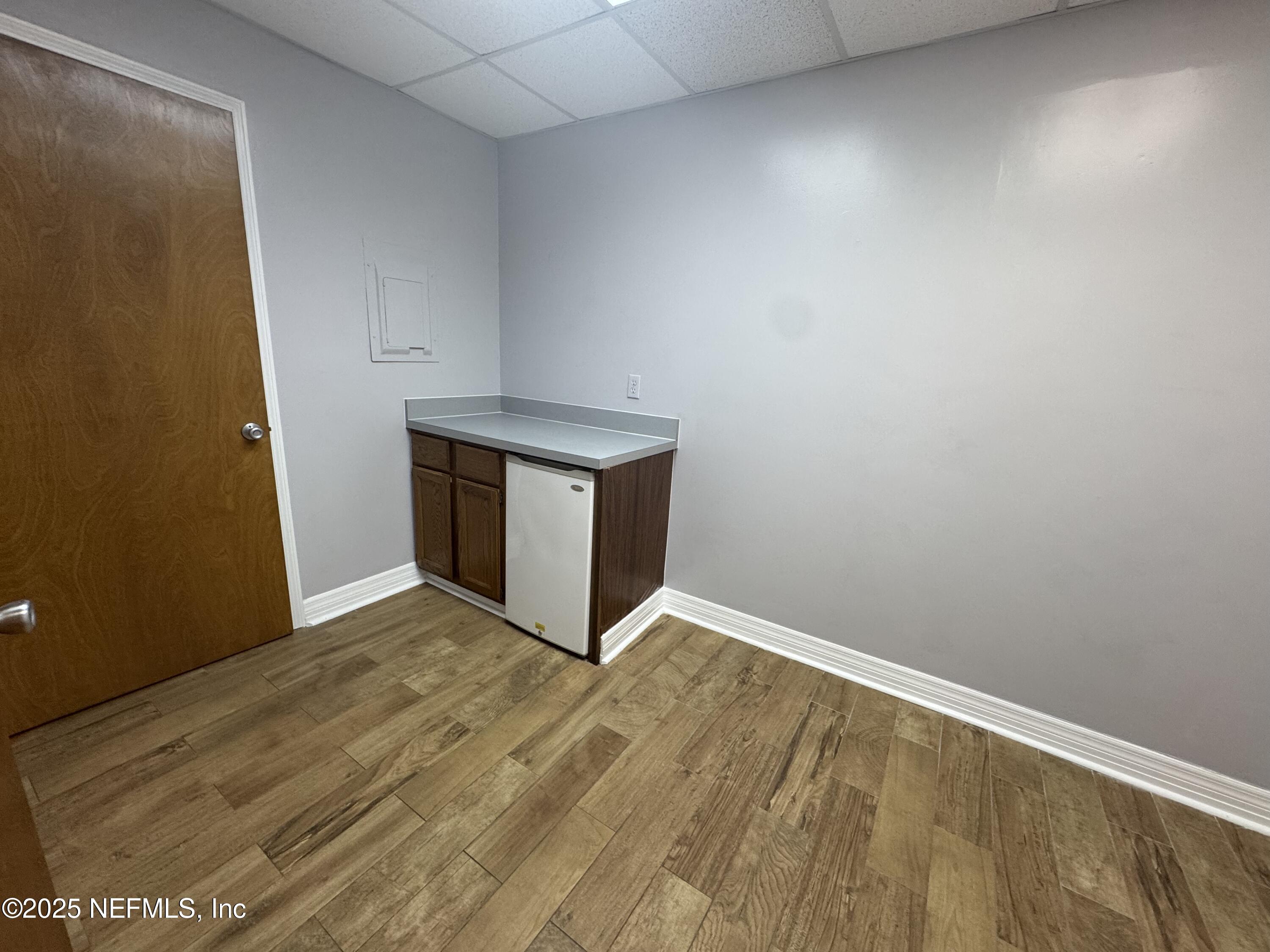 3938 Sunbeam Road Jacksonville, FL 32257 - Photo 26 of 28 a view of an empty room with wooden floor