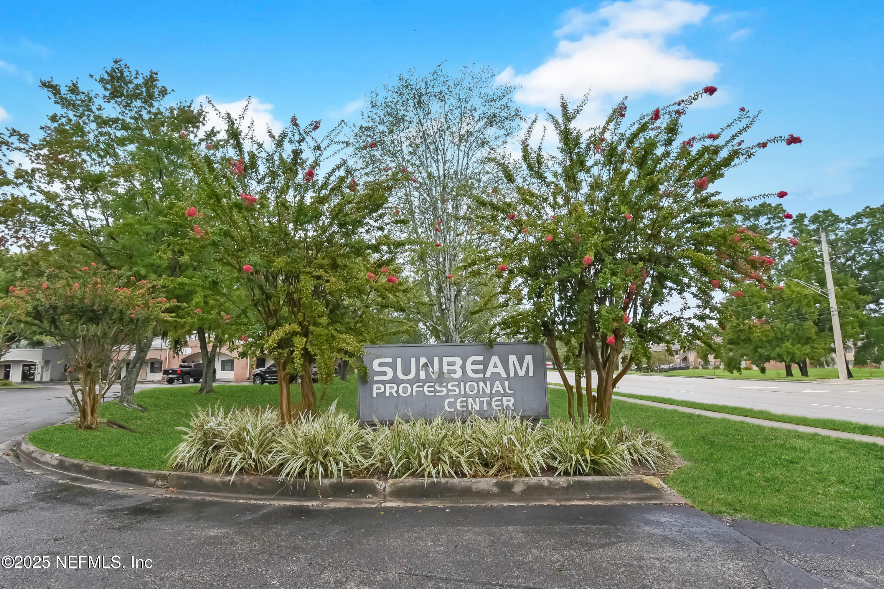 3938 Sunbeam Road Jacksonville, FL 32257 - Photo 28 of 28 a sign that is sitting in front of a house with a garden