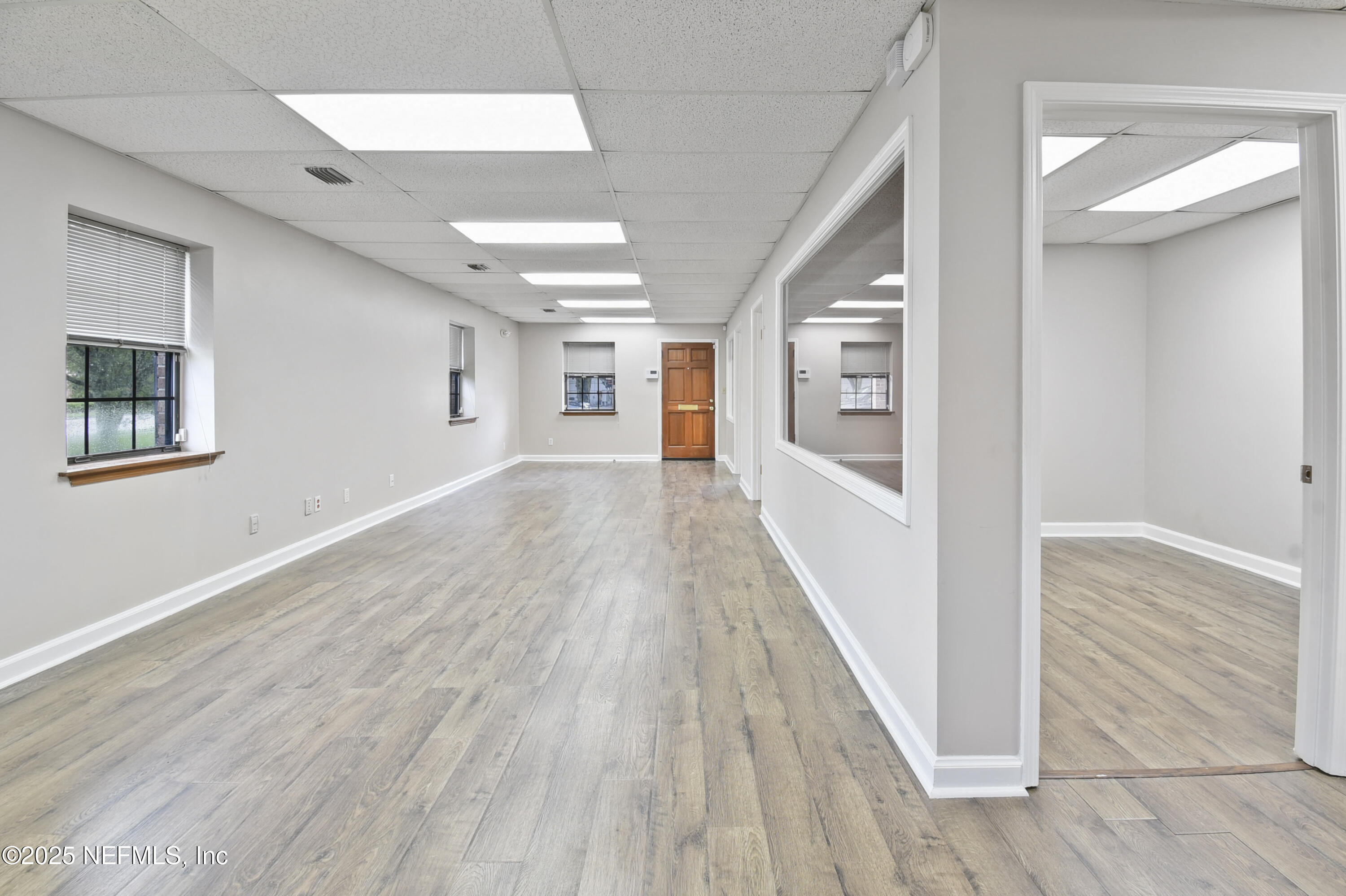 3938 Sunbeam Road Jacksonville, FL 32257 - Photo 4 of 28 a view of a hallway with wooden floor and staircase
