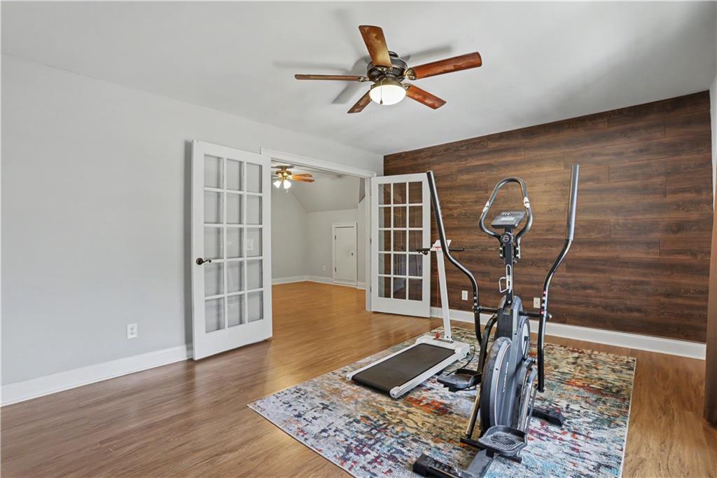 537 Old Collins Road Hoschton, GA 30548 - Photo 30 of 42 a view of a livingroom with wooden floor and a ceiling fan