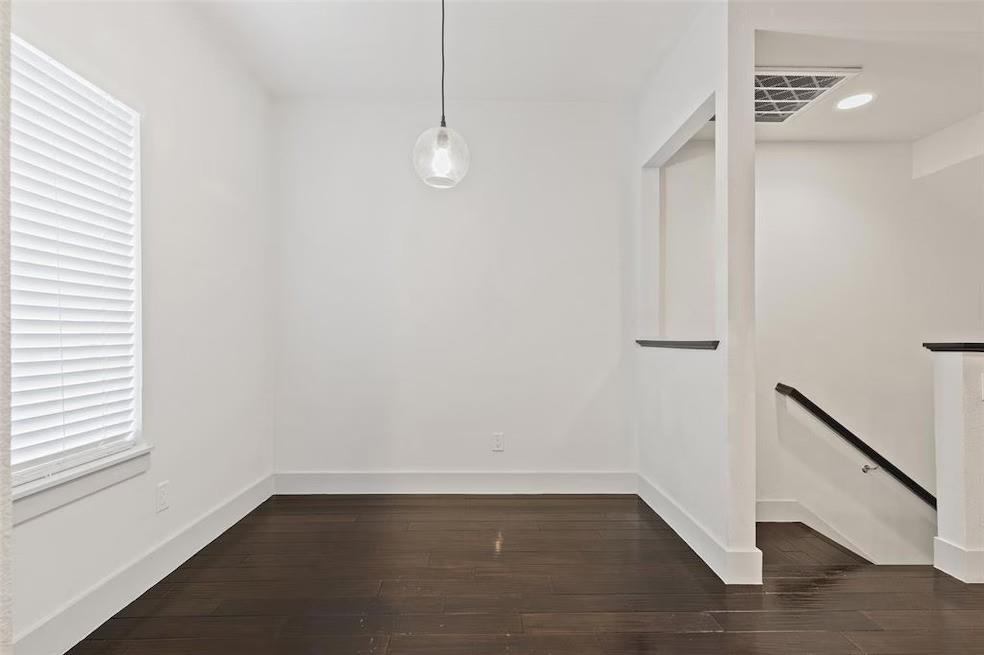 5924 Hudson Street, Unit F Dallas, TX 75206 - Photo 7 of 25 a view of an empty room with wooden floor and a window
