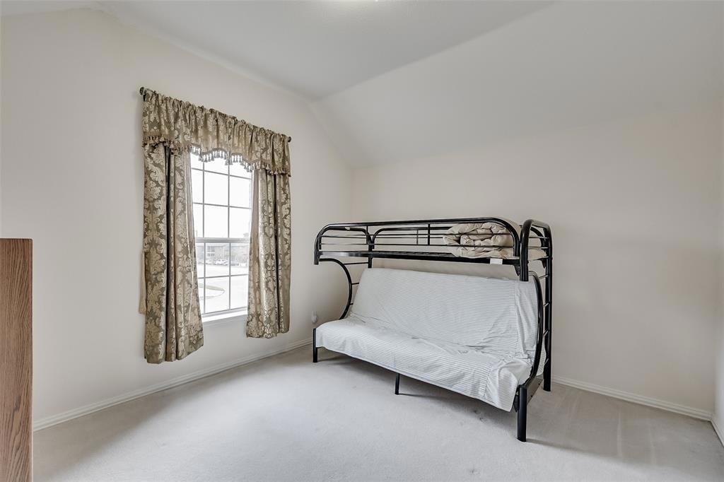 5701 Christy Lane Haltom City, TX 76137 - Photo 12 of 15 Bedroom with carpet floors and lofted ceiling