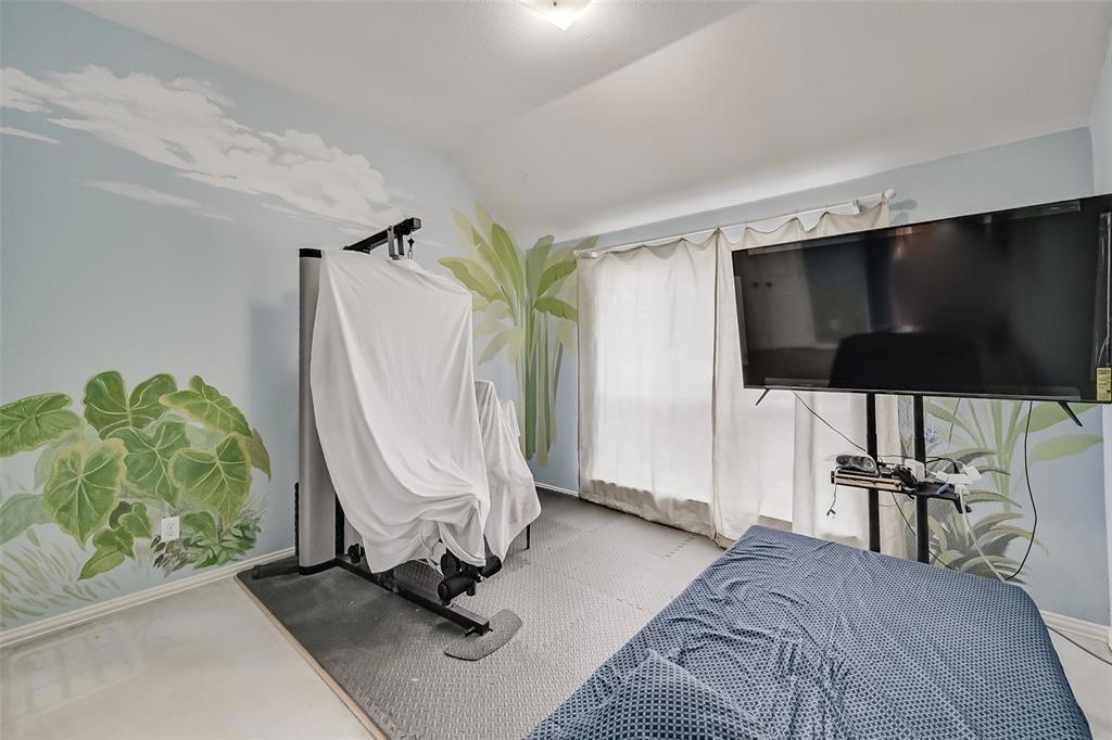 5701 Christy Lane Haltom City, TX 76137 - Photo 13 of 15 Bedroom with vaulted ceiling and baseboards