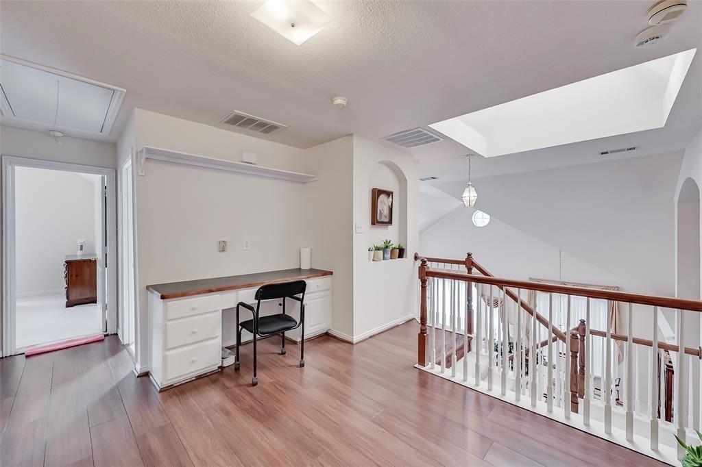 5701 Christy Lane Haltom City, TX 76137 - Photo 14 of 15 Office area with attic access, light wood finished floors, arched walkways, and a textured ceiling
