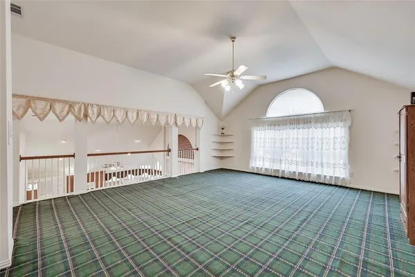 a view of a room with wooden floor staircase and a kitchen