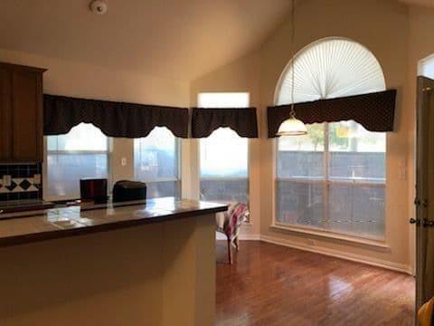 5701 Christy Lane Haltom City, TX 76137 - Photo 2 of 15 Kitchen featuring vaulted ceiling, dark wood-type flooring, pendant lighting, and dark countertops
