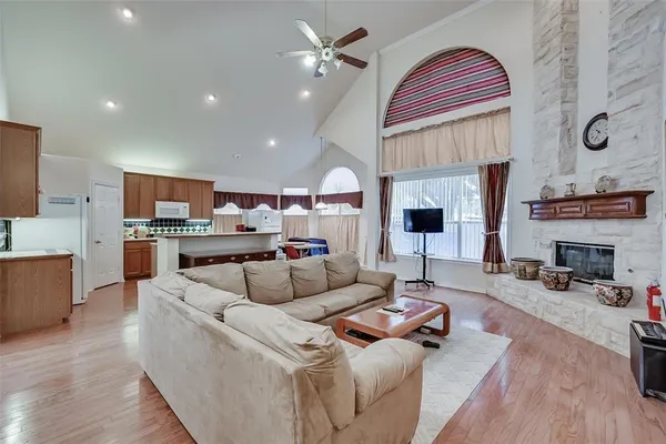 a living room with furniture fireplace and kitchen view