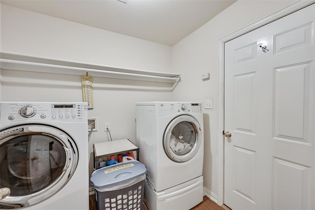 5701 Christy Lane Haltom City, TX 76137 - Photo 5 of 15 Washroom featuring washing machine and dryer and wood finished floors