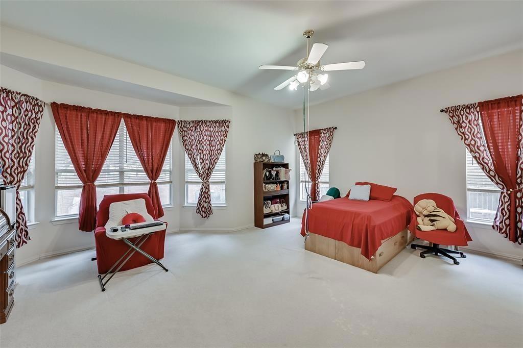5701 Christy Lane Haltom City, TX 76137 - Photo 8 of 15 Carpeted bedroom featuring ceiling fan and baseboards