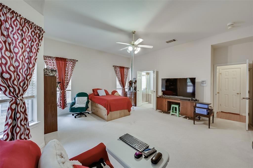 5701 Christy Lane Haltom City, TX 76137 - Photo 9 of 15 Bedroom featuring light colored carpet and ceiling fan