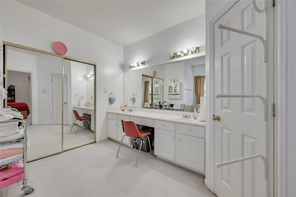 a spacious bathroom with a double vanity sink a mirror and a bathtub