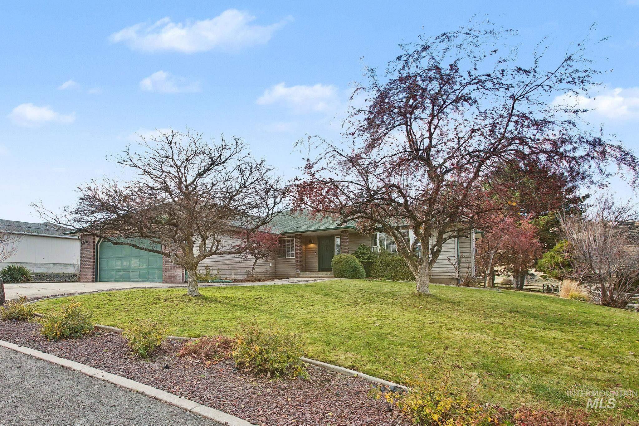 2242 Chukar Lane Clarkston, WA 99403 - Photo 40 of 41 View of front of property featuring a front lawn, concrete driveway, and a garage