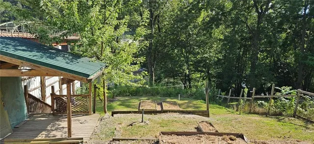 a backyard of a house with table and chairs