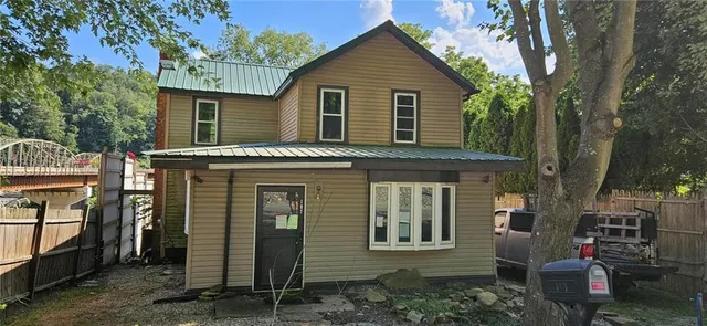 a view of a house with a yard and lawn chairs