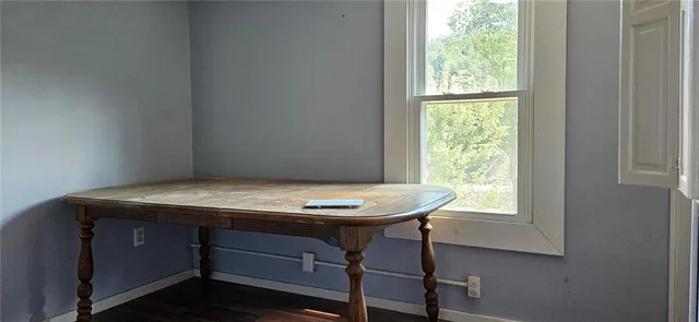 a room with a wooden floor and a window