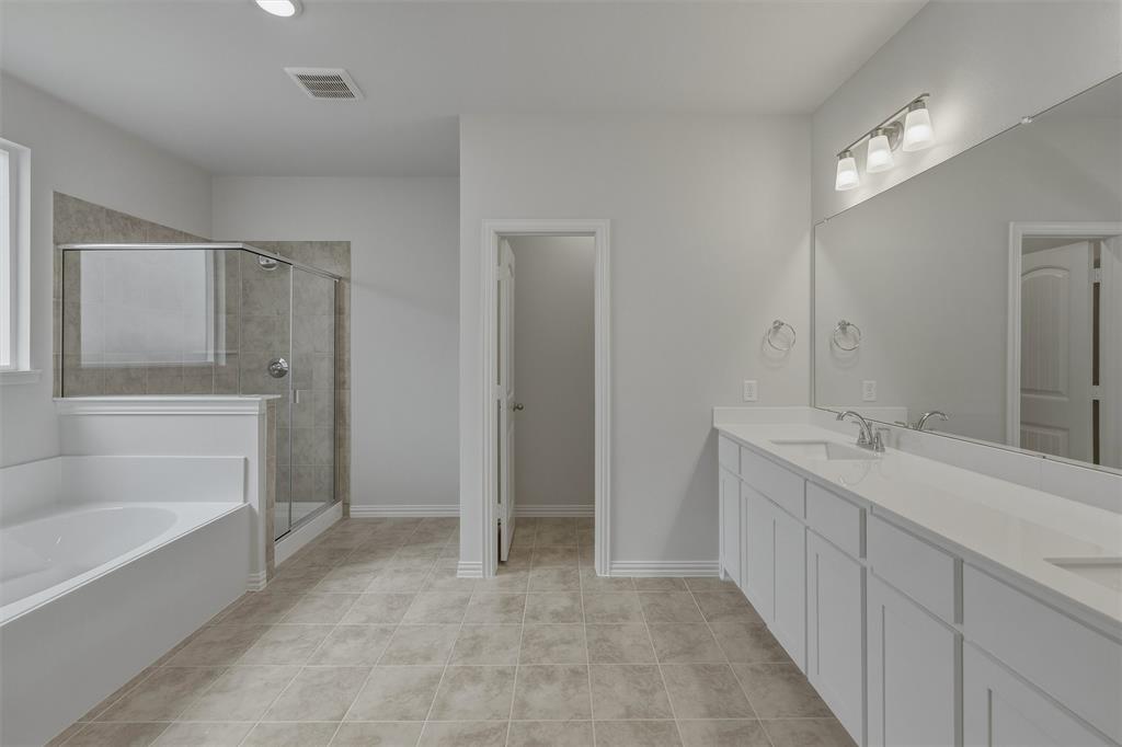 1325 Frio Drive Springtown, TX 76082 - Photo 15 of 24 Spacious bathroom featuring a dual vanity with white cabinetry and an expansive mirror