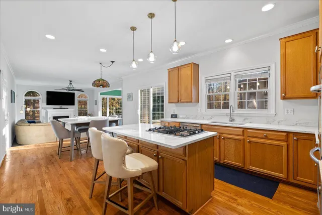 a kitchen with stainless steel appliances granite countertop wooden floor sink and stove