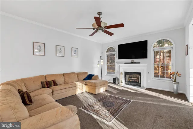 a living room with furniture and a view of kitchen