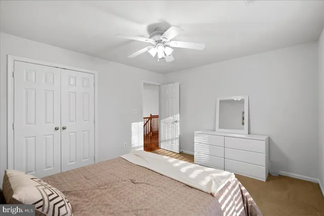 a spacious bedroom with a bed and a chandelier