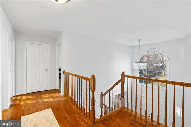 a bedroom with a bed and a flat tv screen on dresser
