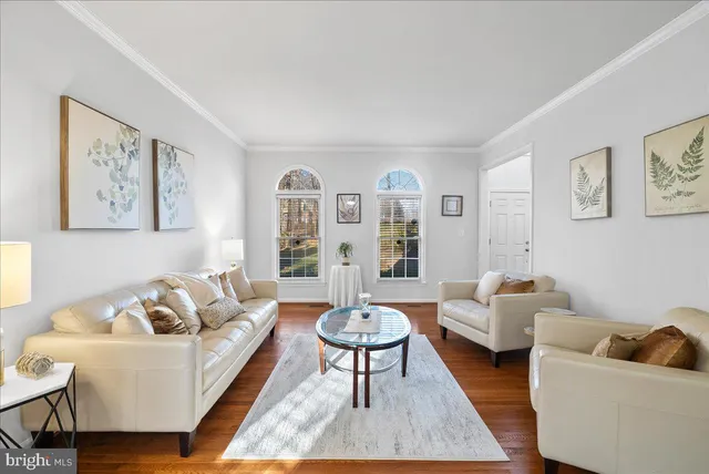 a living room with furniture a rug and a large window