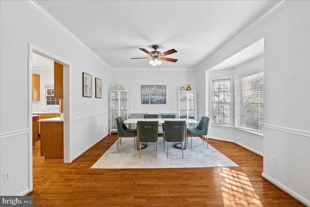 a view of a dining room with furniture a chandelier and wooden floor