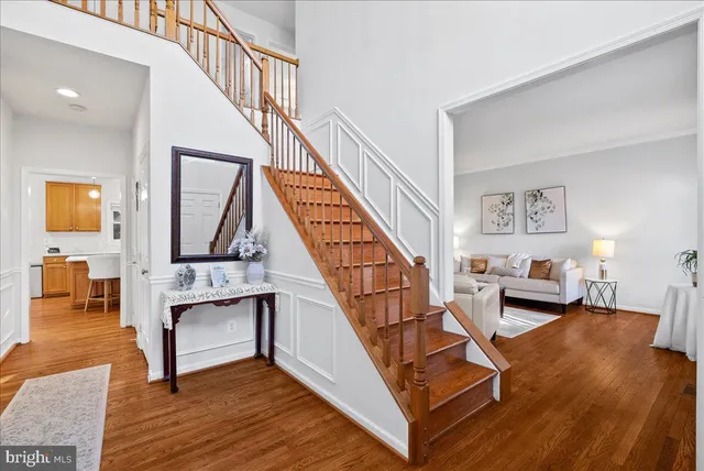 a view of an entryway with wooden floor and stairs