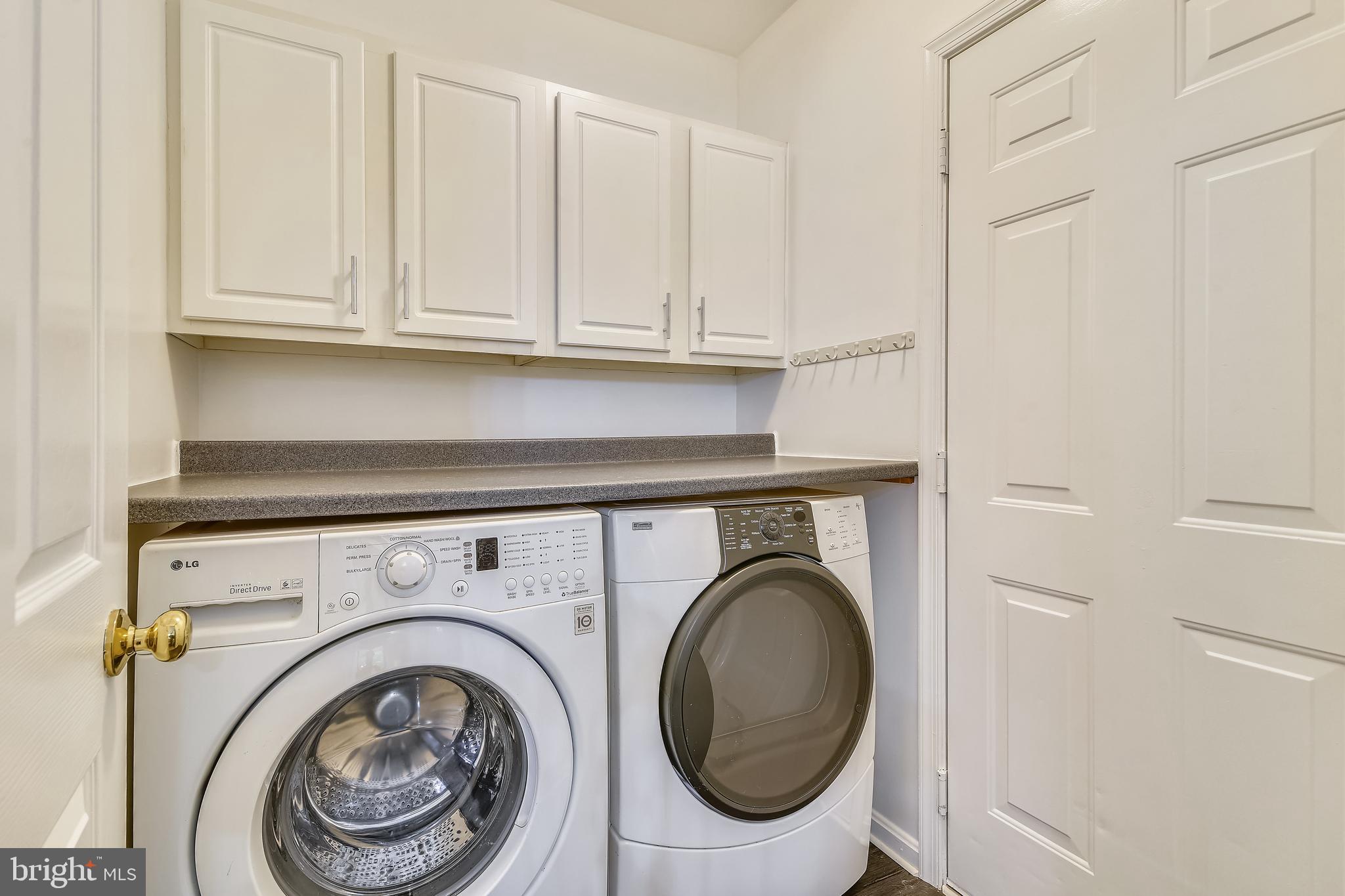 21558 Awbrey Place Broadlands, VA 20148 - Photo 22 of 45 LAUNDRY ROOM WITH FRONT LOAD WASHER + DRYER + CABS