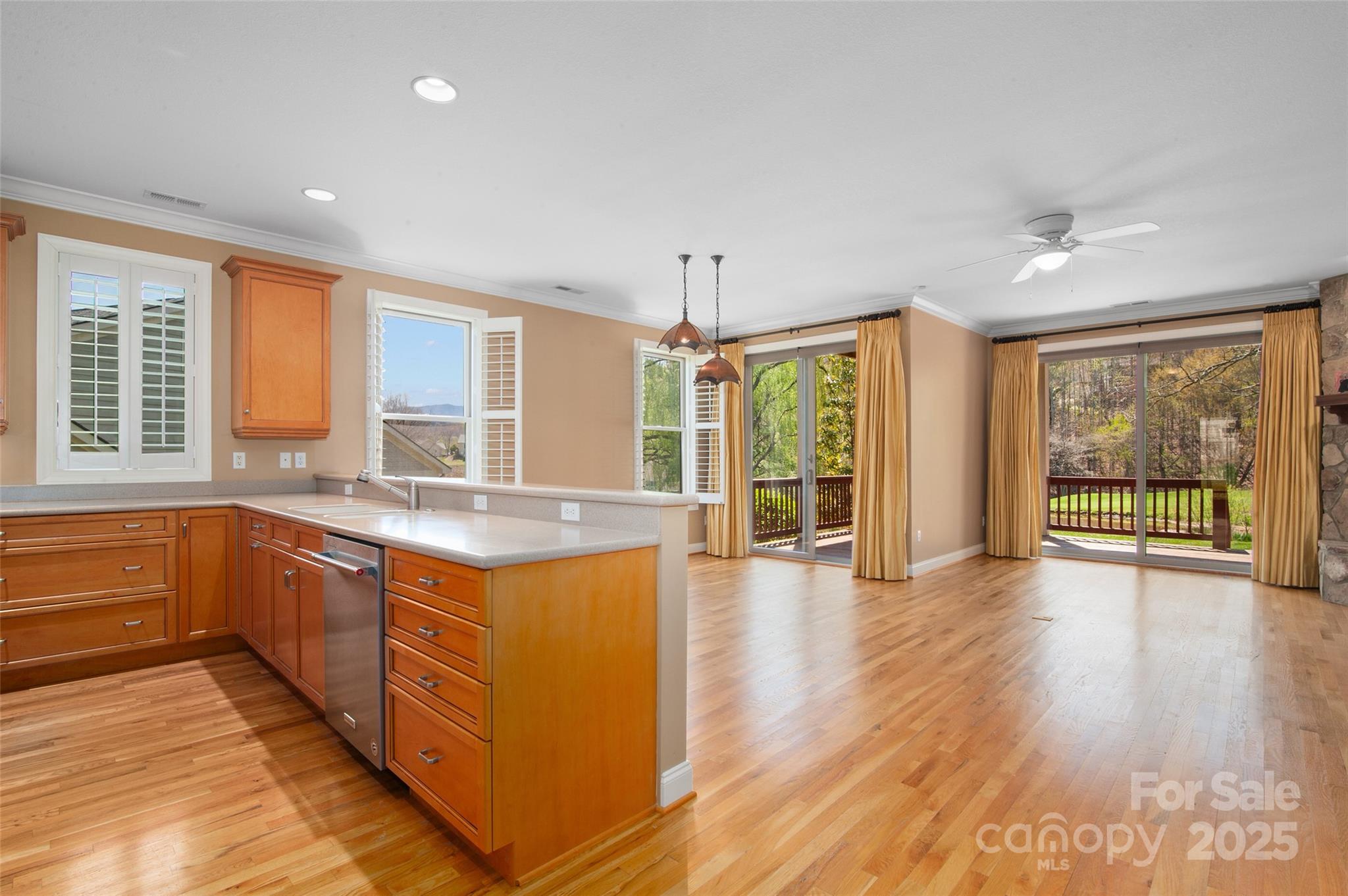 111 Augusta Circle Waynesville, NC 28786 - Photo 13 of 41 a open kitchen with granite countertop a stove top oven a sink with wooden cabinets and floor