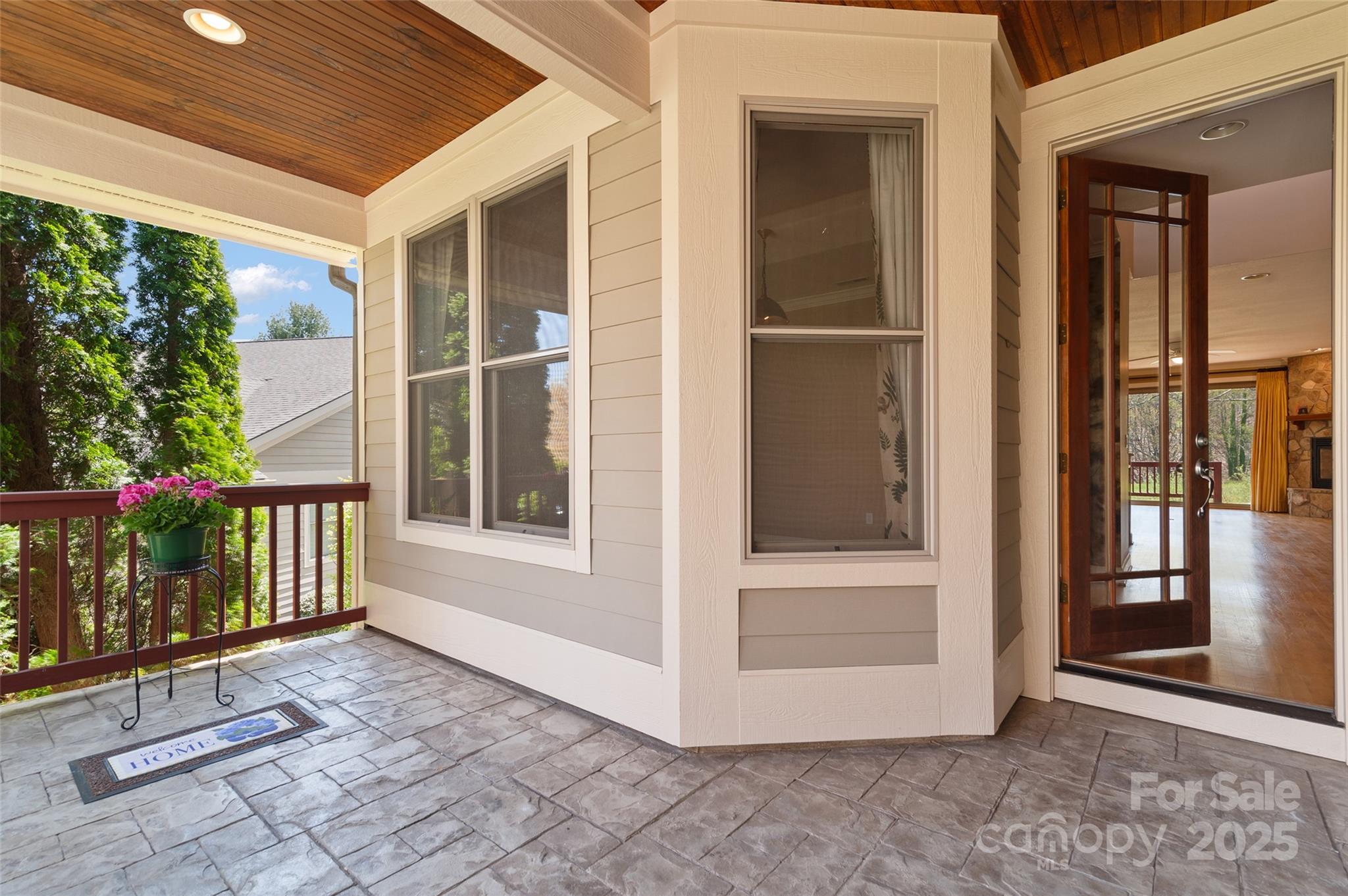 111 Augusta Circle Waynesville, NC 28786 - Photo 6 of 41 a view of a porch with a floor to ceiling window and wooden floor
