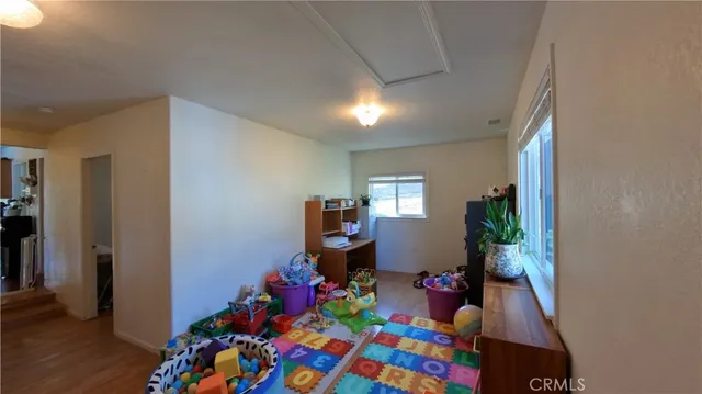 a bedroom with a bed and a flat tv screen