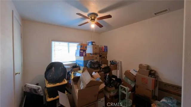 a kitchen with stainless steel appliances a stove a refrigerator a sink a stove wooden floor cabinets and dining table